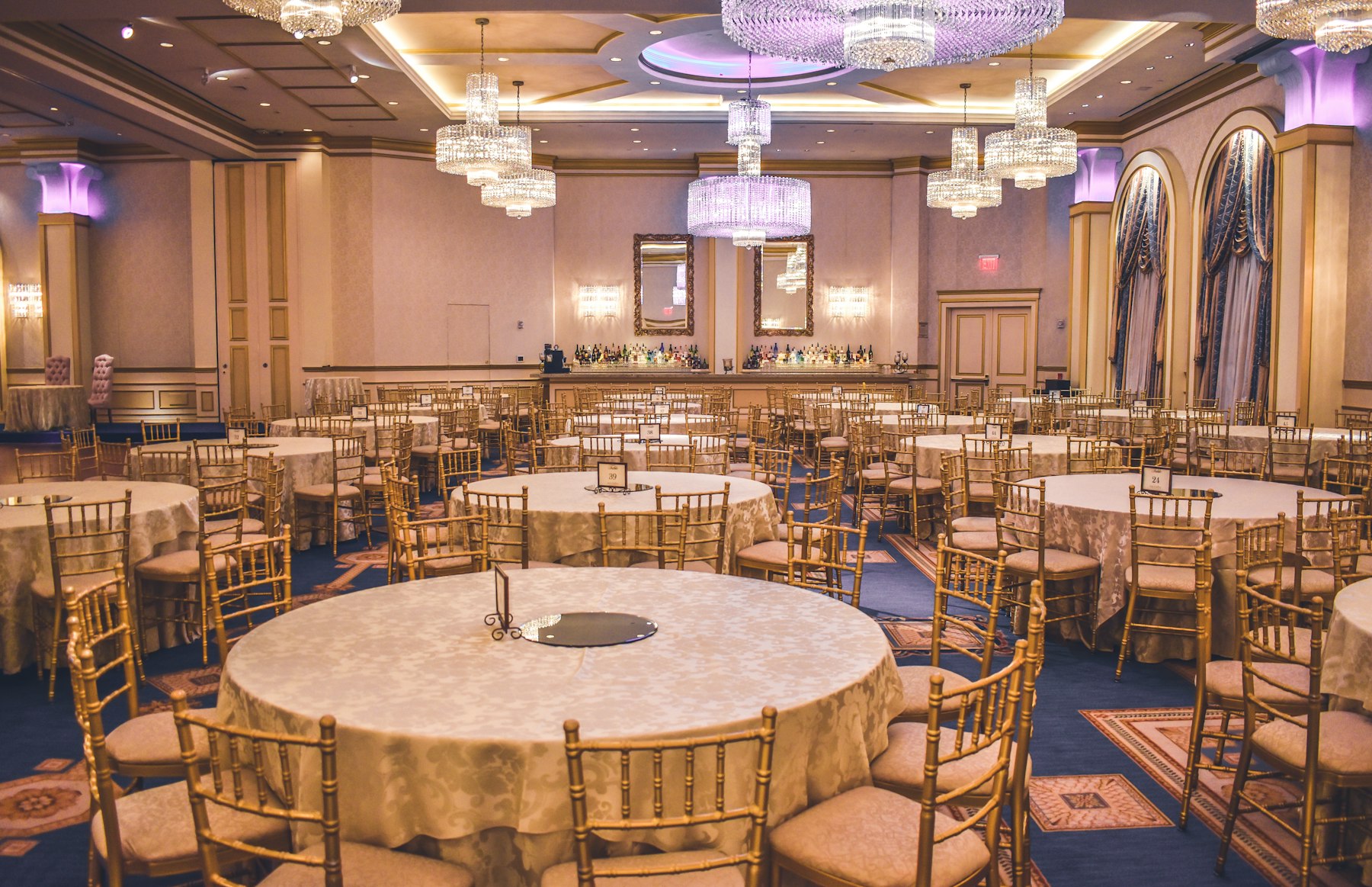 Ballroom set with round tables and gold chairs